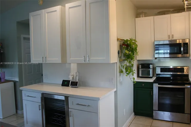 a kitchen with stainless steel appliances a stove a microwave and a cabinets