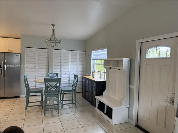 a dining room with furniture and window