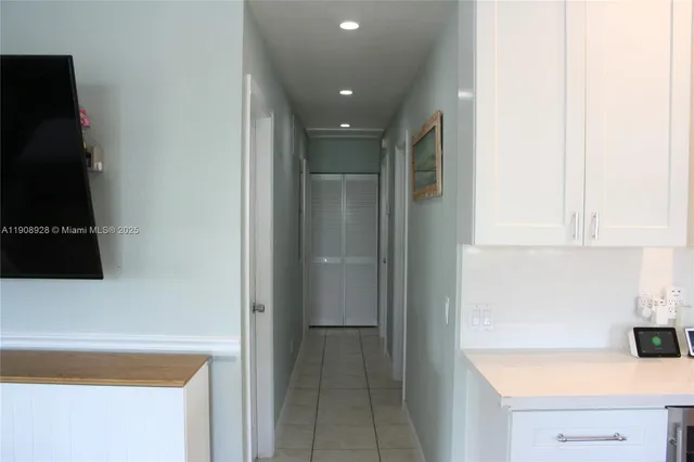 a kitchen with a refrigerator and cabinets
