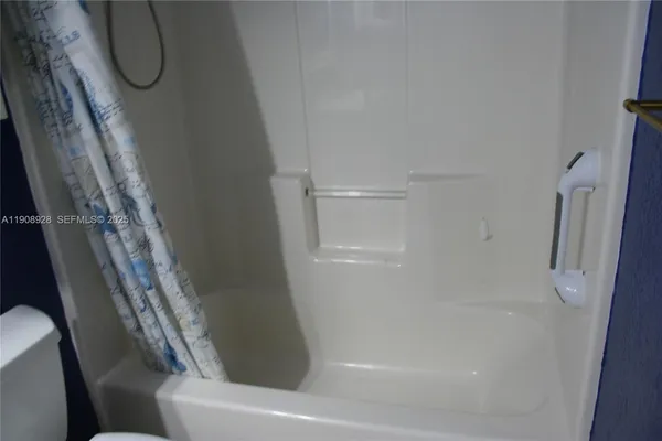 a bathroom with a toilet sink and shower