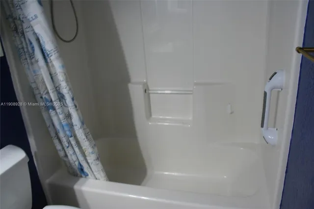 a bathroom with a toilet sink and shower