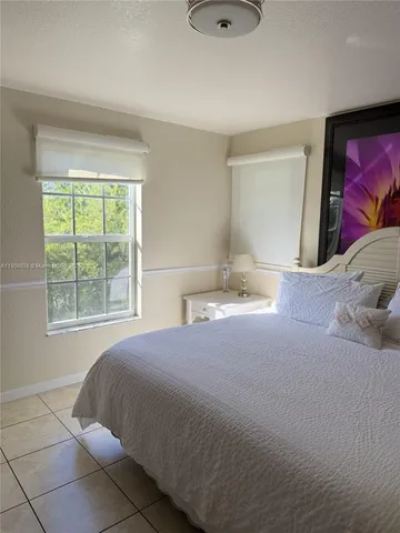 a room with a flat screen tv and walk in closet