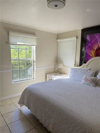 a room with a flat screen tv and walk in closet