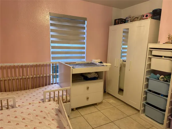 a view of room with bed and furniture