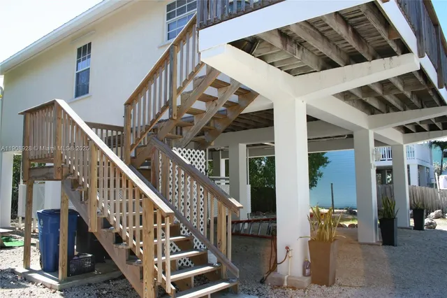 a view of staircase with lots of frames on wall and a chandelier