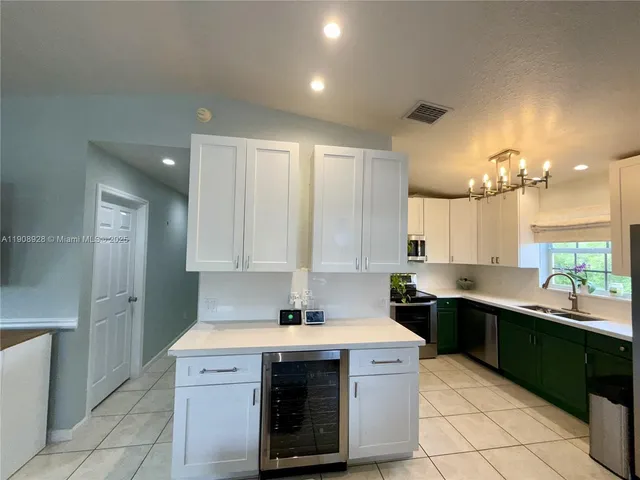 a kitchen with a sink cabinets and window