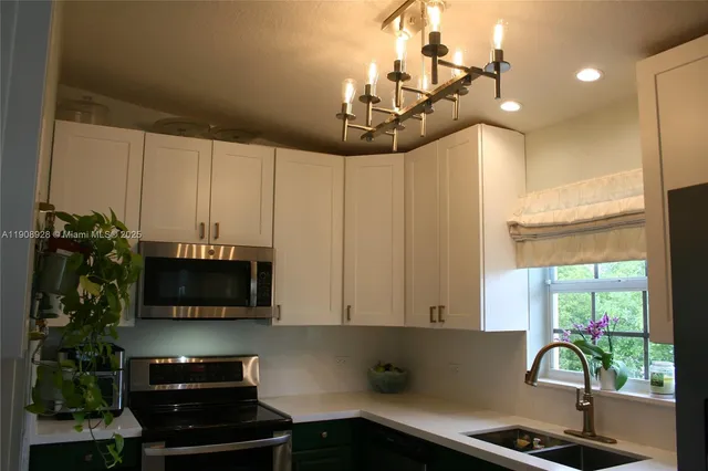 a kitchen with a refrigerator a sink and cabinets