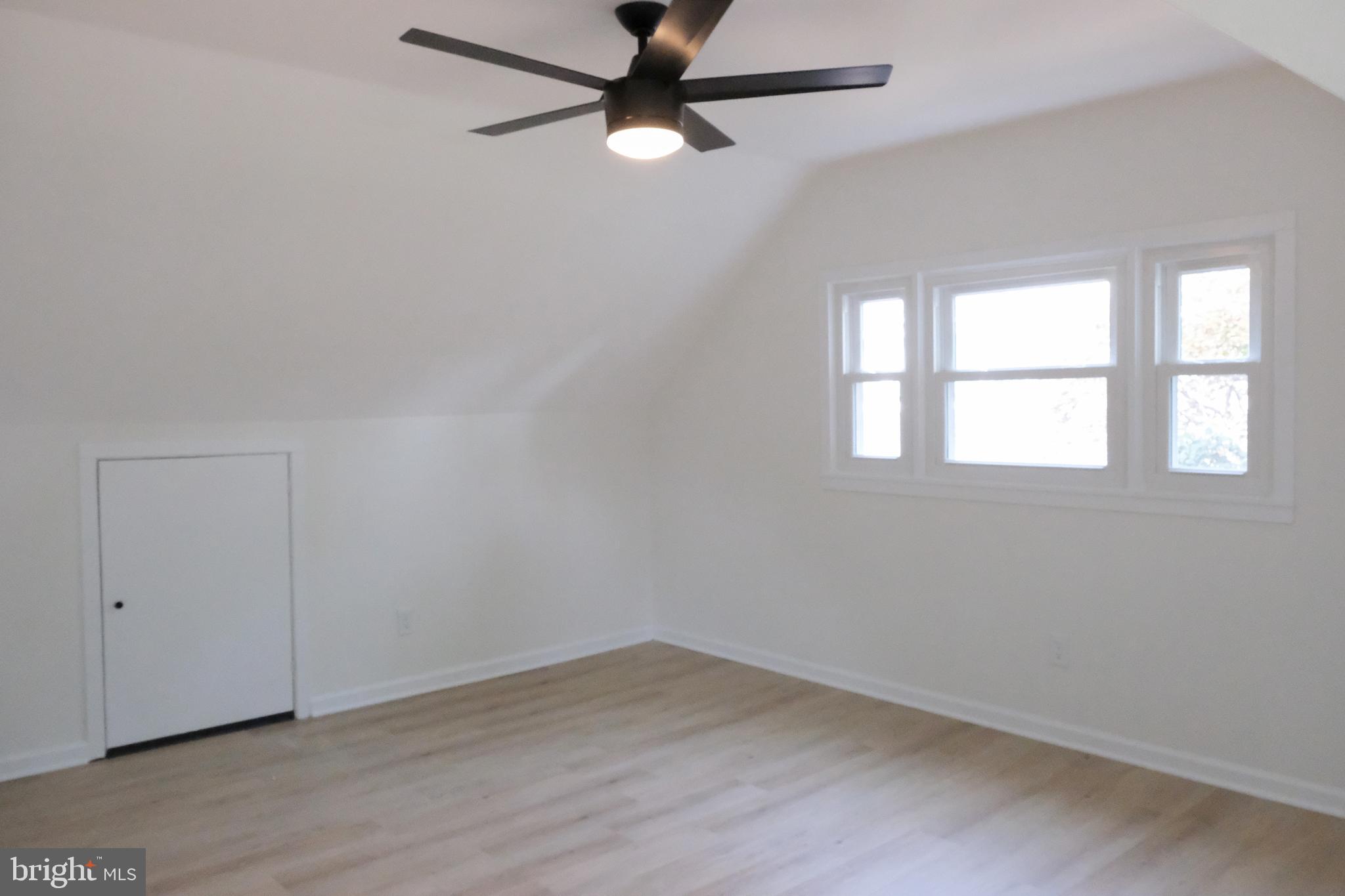 1825 Tilton Drive Silver Spring, MD 20902 - Photo 20 of 31 an empty room with wooden floor fan and windows
