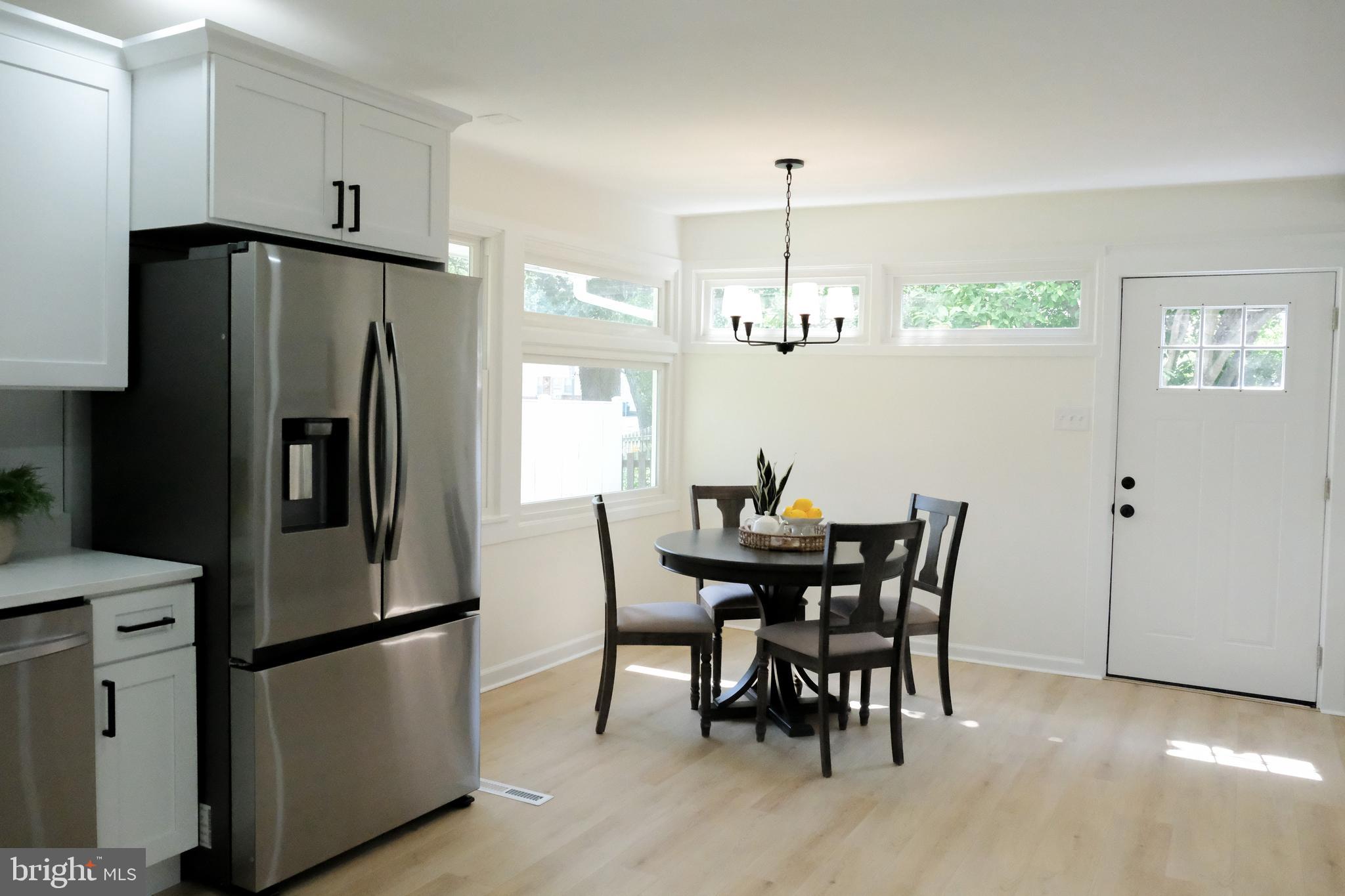 1825 Tilton Drive Silver Spring, MD 20902 - Photo 27 of 31 a kitchen with stainless steel appliances granite countertop a dining table and chairs