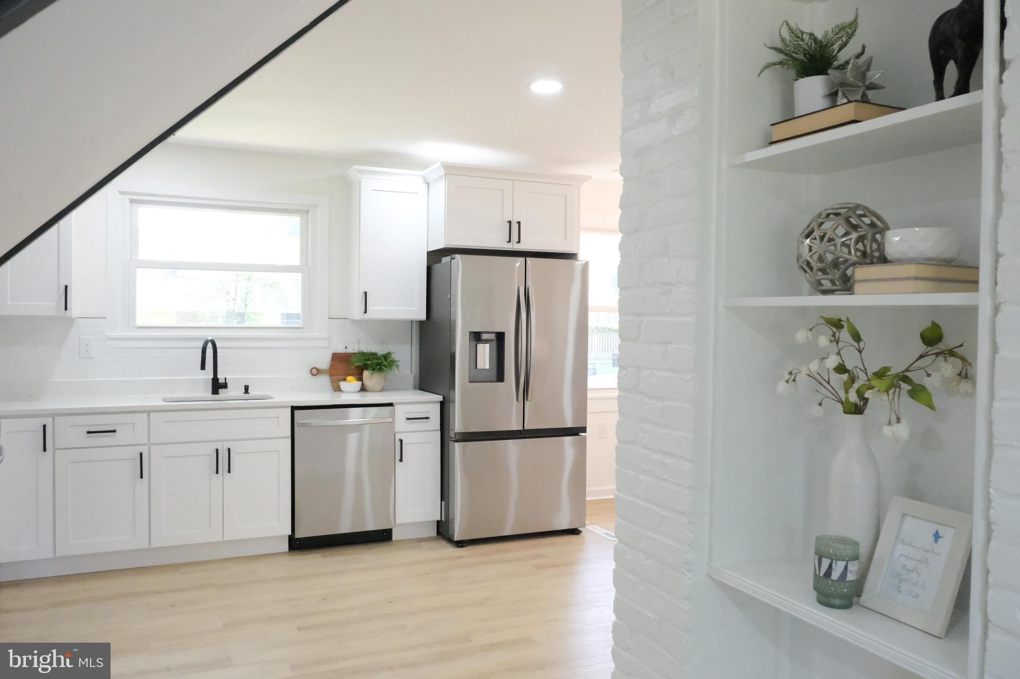 1825 Tilton Drive Silver Spring, MD 20902 - Photo 28 of 31 a kitchen with stainless steel appliances a refrigerator sink and microwave