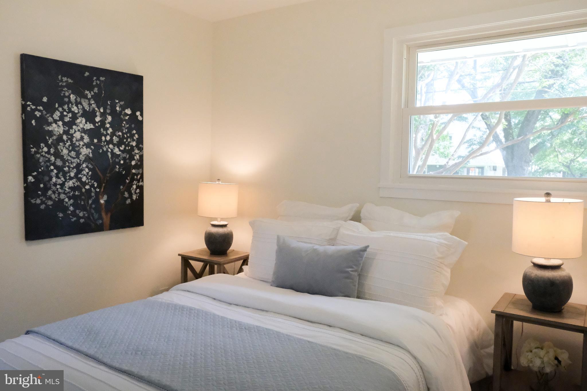 1825 Tilton Drive Silver Spring, MD 20902 - Photo 8 of 31 a bedroom with a bed and wooden floor