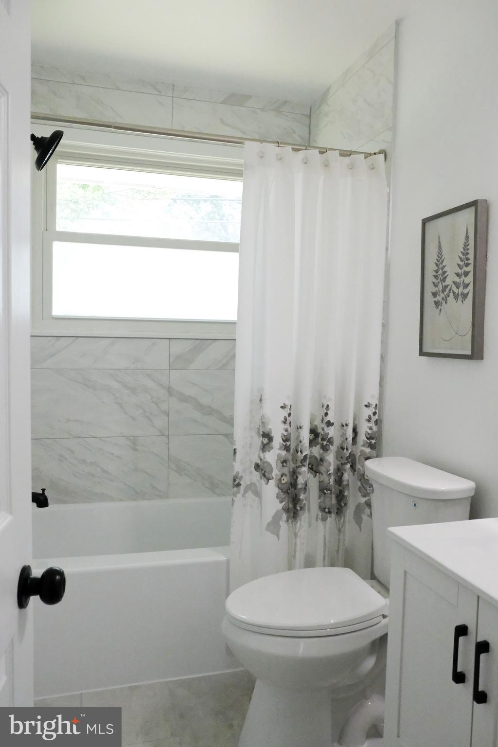 1825 Tilton Drive Silver Spring, MD 20902 - Photo 9 of 31 a white toilet sitting next to a bath tub