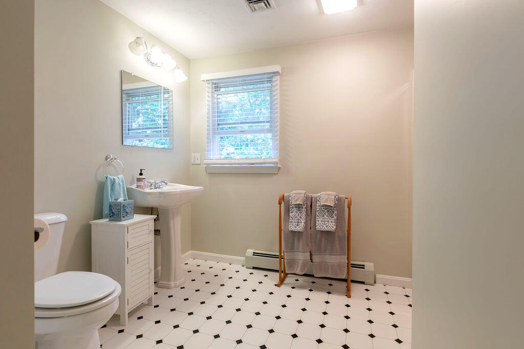 17 Valley Road Mashpee, MA 02649 - Photo 13 of 19 a bathroom with a toilet a window and a rug