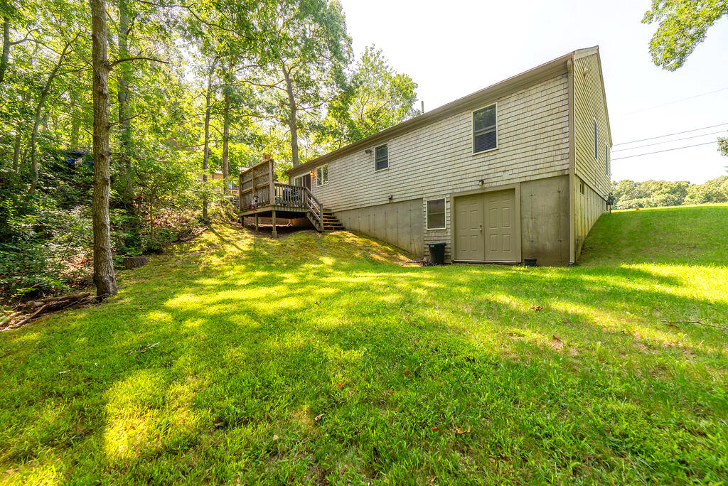 17 Valley Road Mashpee, MA 02649 - Photo 17 of 19 a view of a backyard with plants and large tree