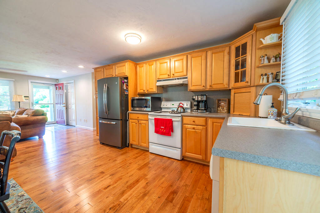 17 Valley Road Mashpee, MA 02649 - Photo 3 of 19 a kitchen with stainless steel appliances a refrigerator a sink a stove and wooden floor