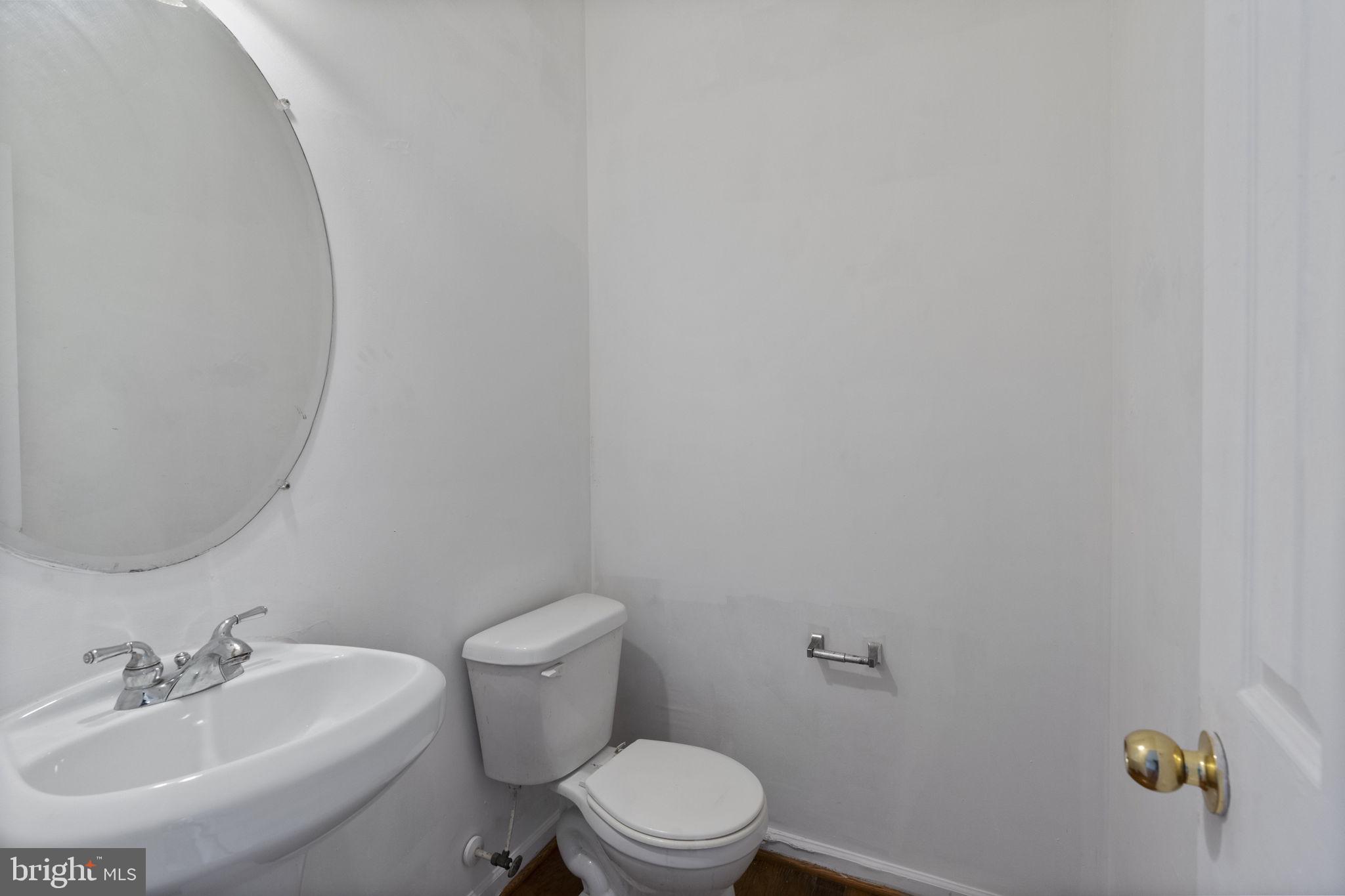 811 Middle River Road Baltimore, MD 21220 - Photo 12 of 55 a bathroom with a sink and a toilet