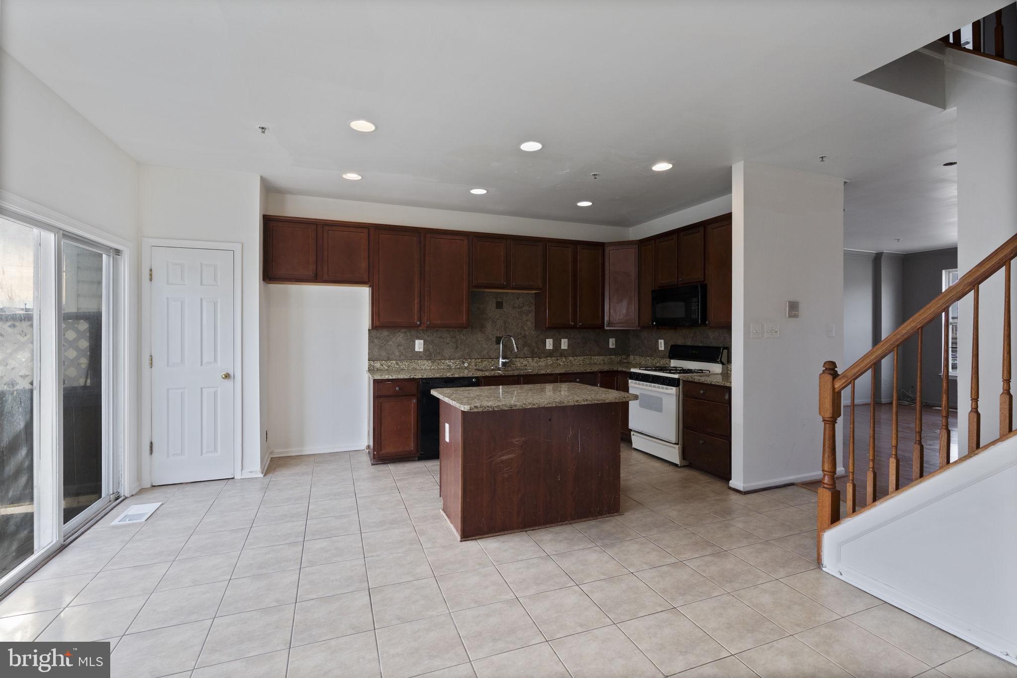 811 Middle River Road Baltimore, MD 21220 - Photo 16 of 55 a kitchen with stainless steel appliances granite countertop a refrigerator and a sink