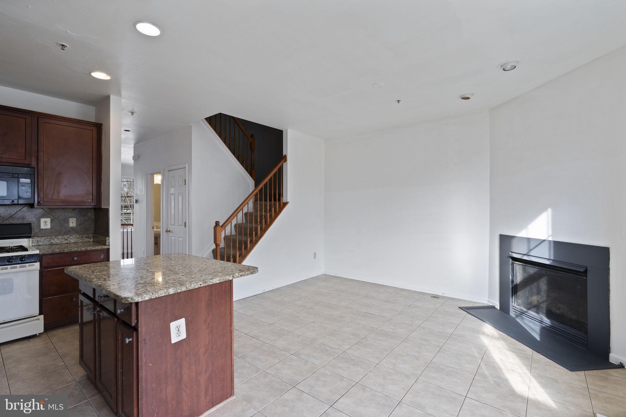 811 Middle River Road Baltimore, MD 21220 - Photo 18 of 55 a kitchen with kitchen island granite countertop a stove and a sink