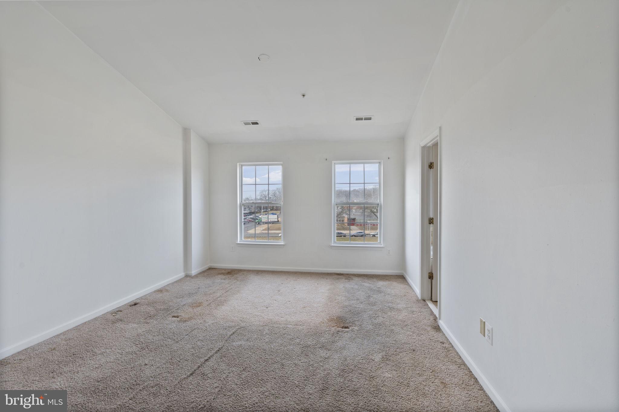 811 Middle River Road Baltimore, MD 21220 - Photo 20 of 55 a view of an empty room with windows