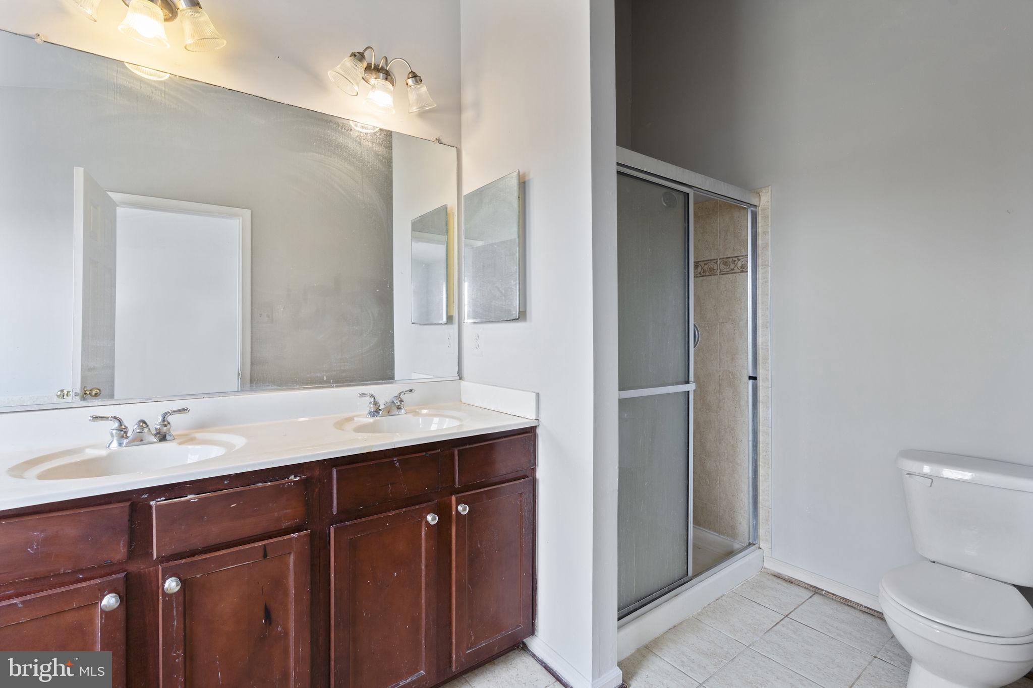 811 Middle River Road Baltimore, MD 21220 - Photo 27 of 55 a bathroom with a sink a toilet and shower