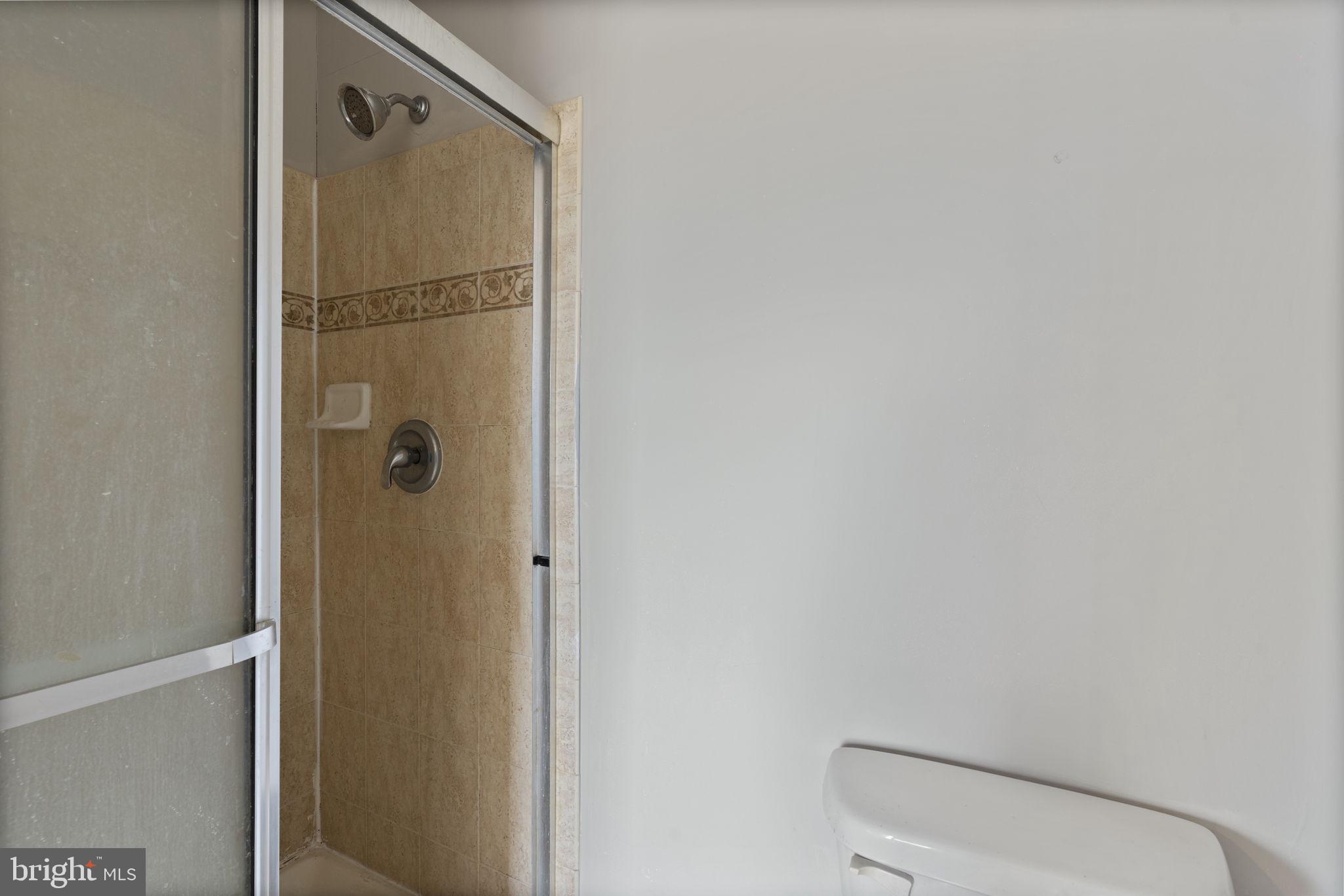 811 Middle River Road Baltimore, MD 21220 - Photo 28 of 55 a bathroom with a shower and toilet