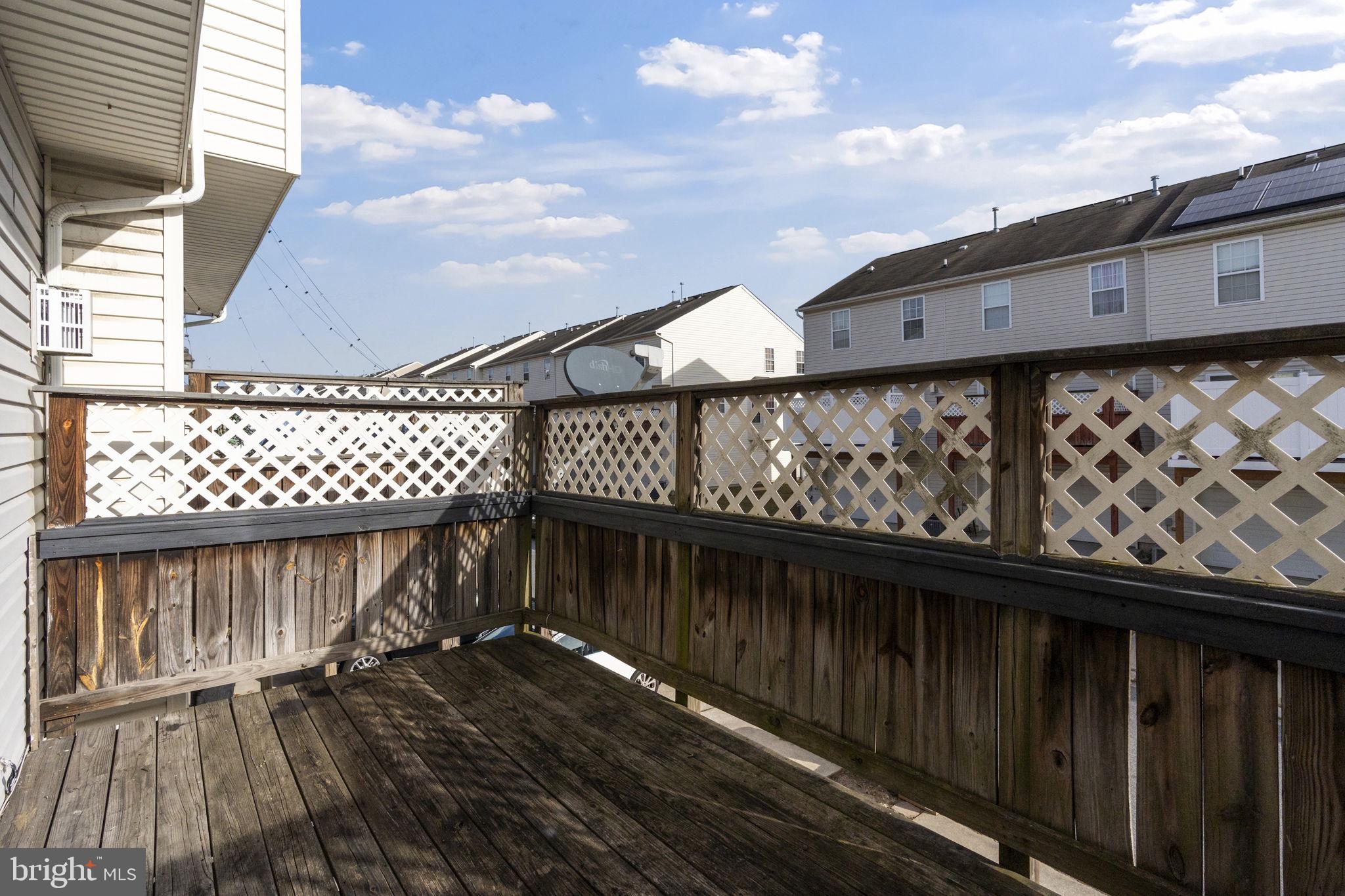 811 Middle River Road Baltimore, MD 21220 - Photo 43 of 55 a view of a balcony with wooden floor and fence