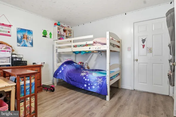 a bedroom with a bed and a desk