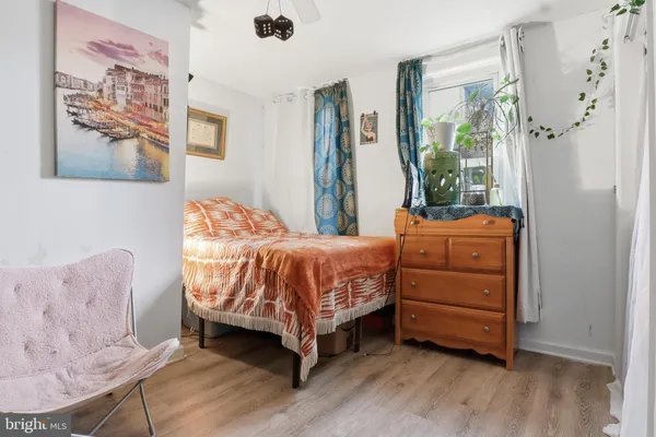 a bedroom with a bed closet and flat screen tv