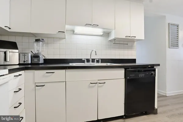 a kitchen with a sink and cabinets