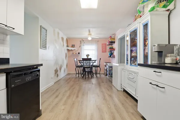 a kitchen with sink cabinets and wooden floor