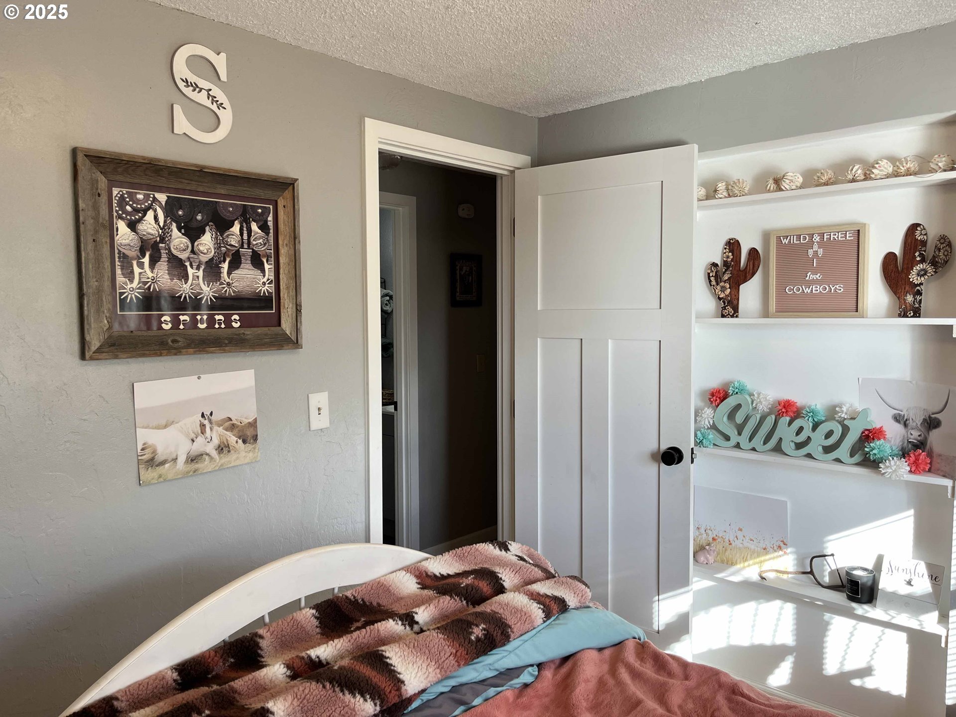 2045 19th Street Florence, OR 97439 - Photo 13 of 43 a bedroom with a bed and painting on the wall