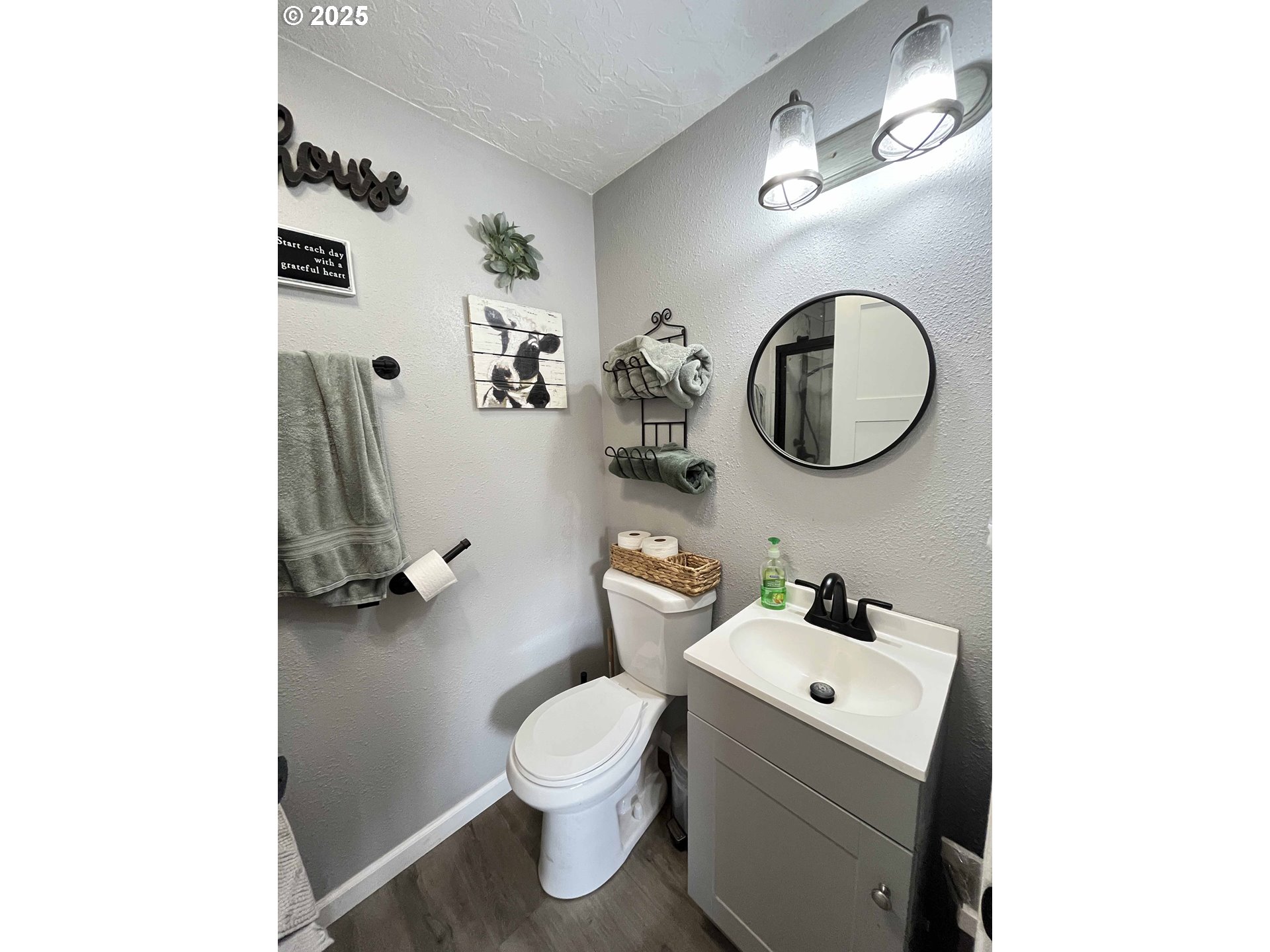 2045 19th Street Florence, OR 97439 - Photo 14 of 43 a bathroom with a toilet sink and mirror