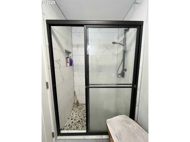 a bedroom with a bed and flat screen tv