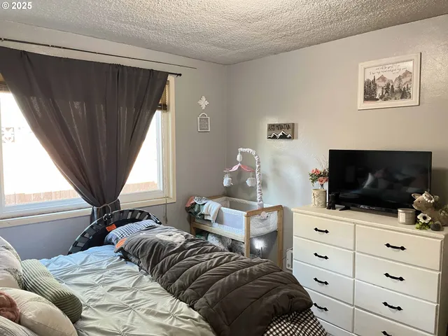 a bedroom with a bed and a potted plant