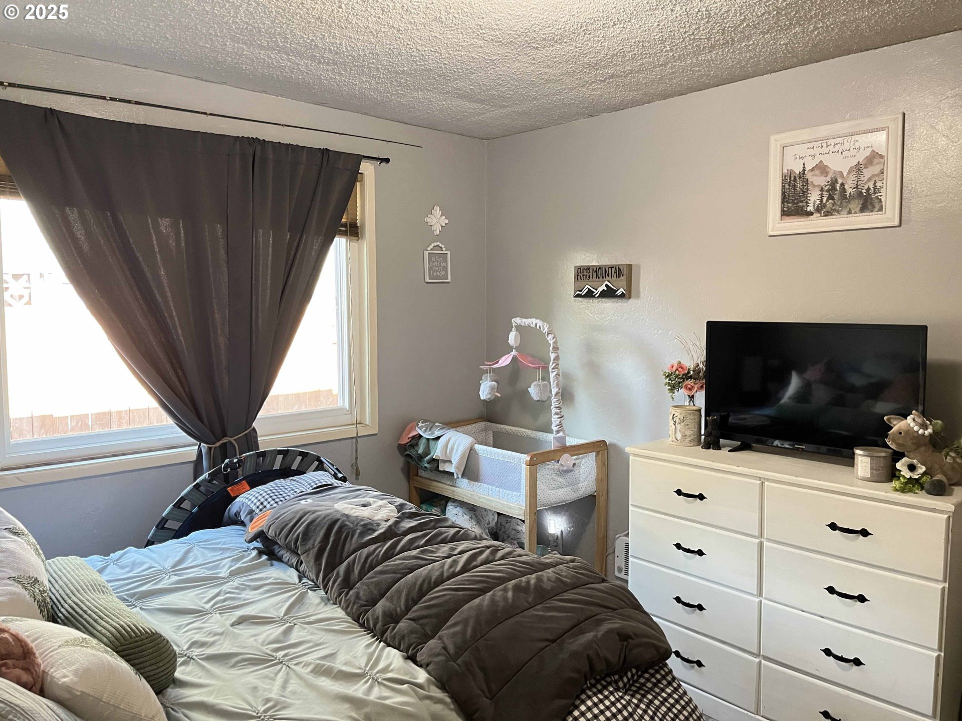 2045 19th Street Florence, OR 97439 - Photo 16 of 43 a bedroom with a bed and flat screen tv
