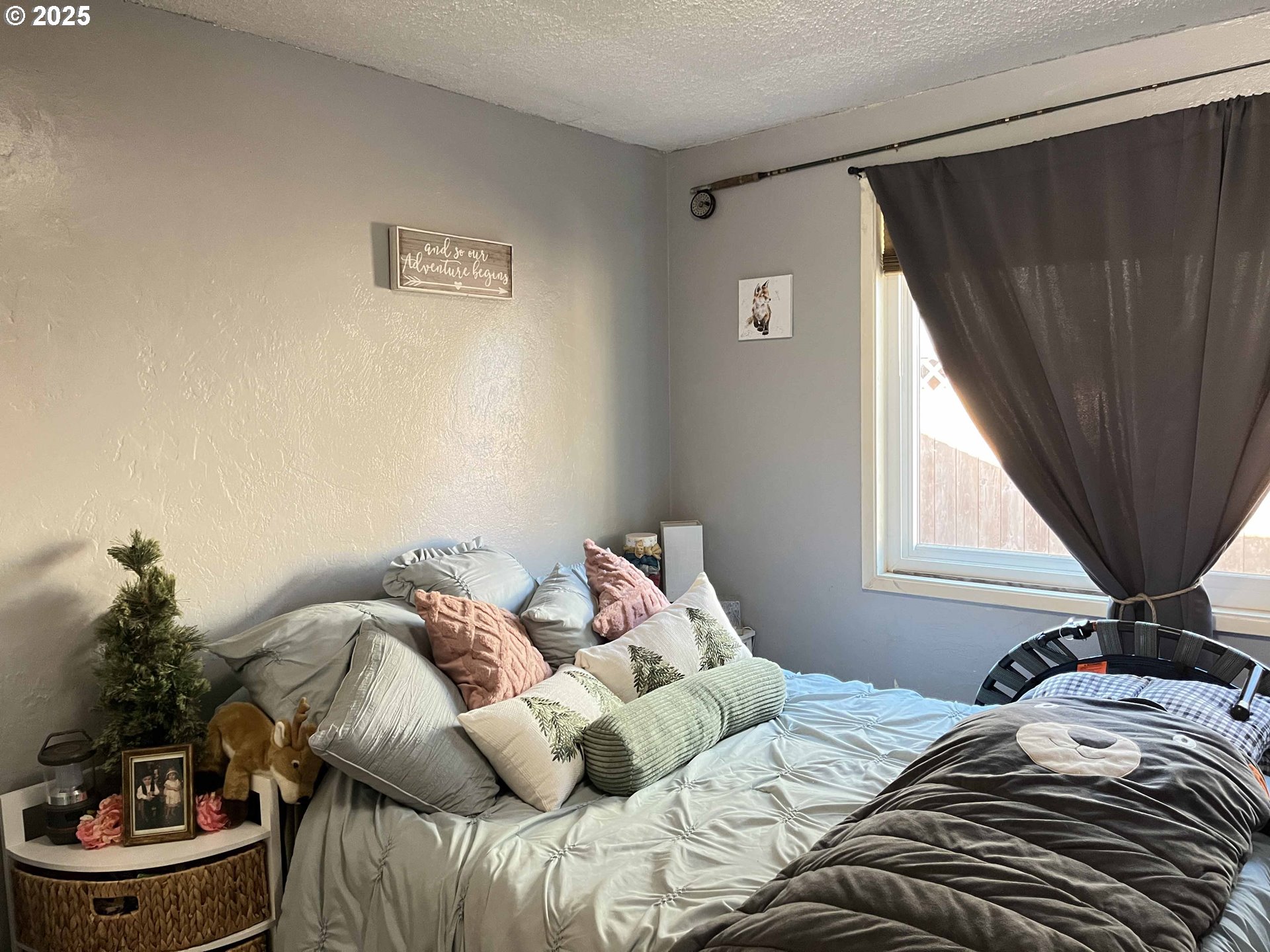 2045 19th Street Florence, OR 97439 - Photo 17 of 43 a bedroom with a bed and a potted plant