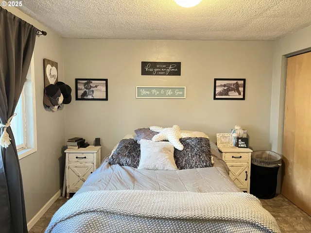 a bed room with a bed and a curtain