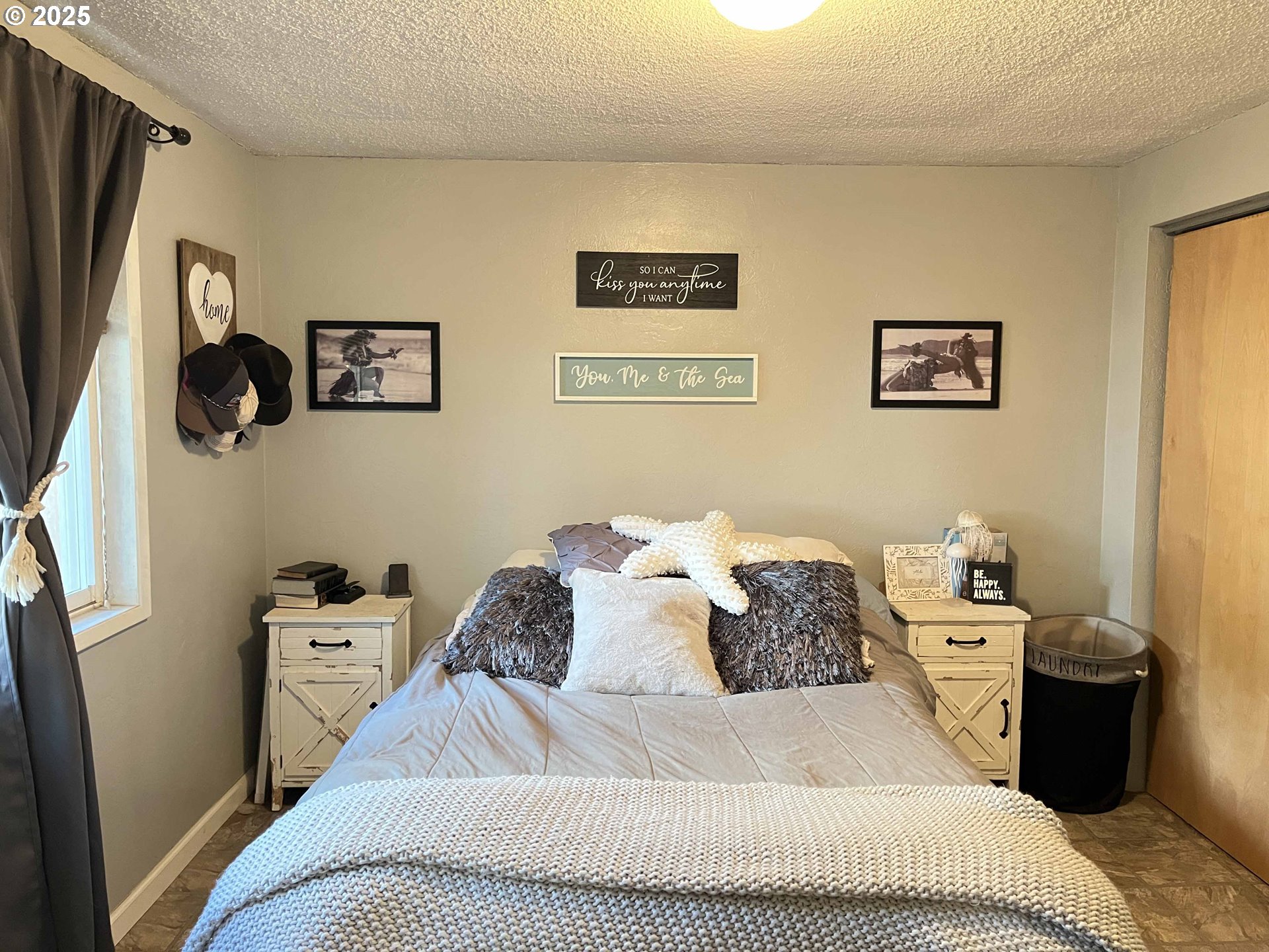 2045 19th Street Florence, OR 97439 - Photo 19 of 43 a bedroom with a bed and the wall painting