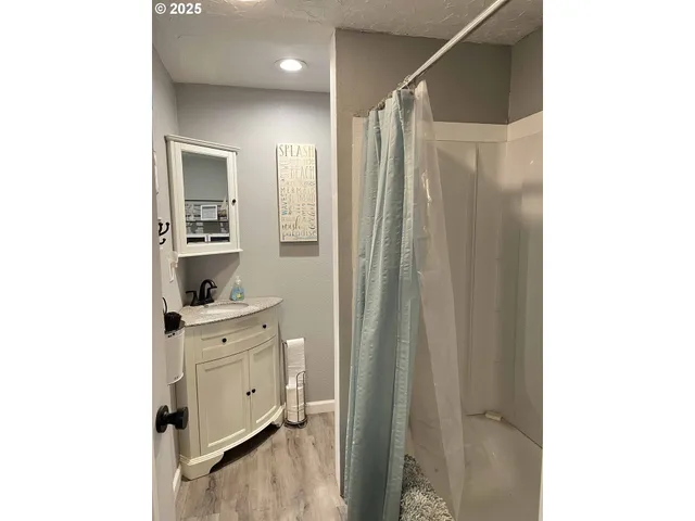 a bathroom with a granite countertop toilet sink and mirror