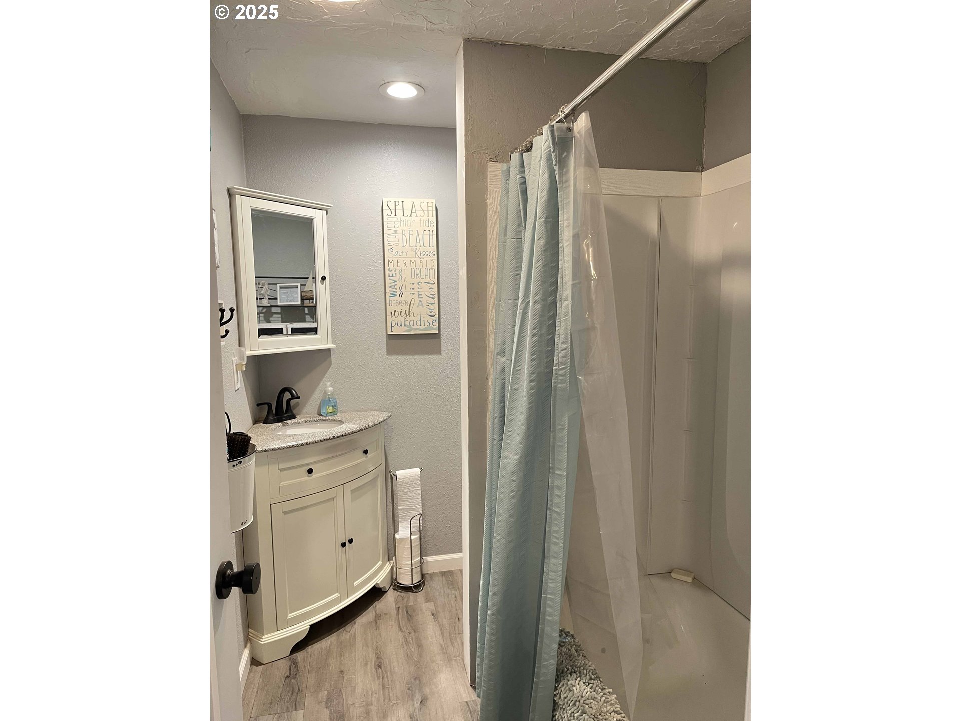 2045 19th Street Florence, OR 97439 - Photo 22 of 43 a spacious bathroom with a shower and a sink