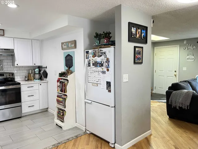 a kitchen with stainless steel appliances granite countertop a stove and a sink