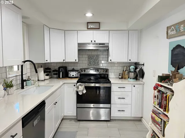 a kitchen with stainless steel appliances a stove and cabinets