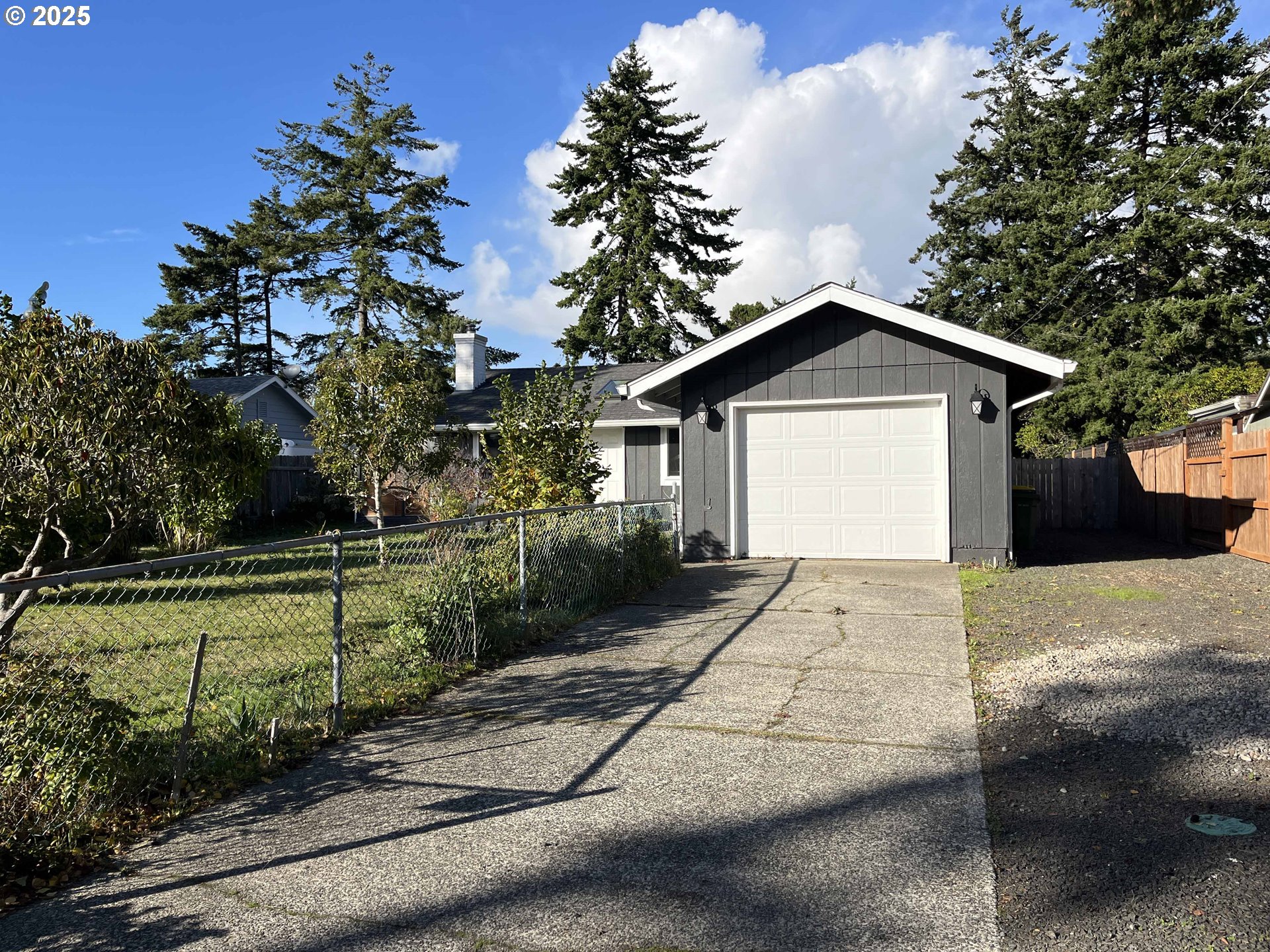 2045 19th Street Florence, OR 97439 - Photo 3 of 43 a view of a house with a yard