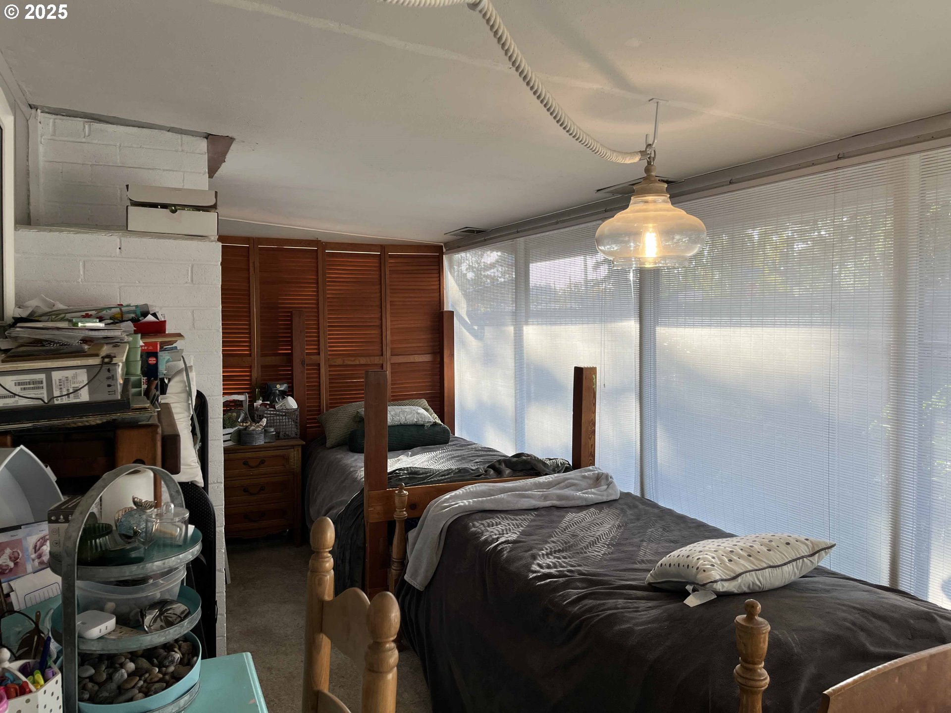 2045 19th Street Florence, OR 97439 - Photo 32 of 43 a bedroom with a bed and a chandelier