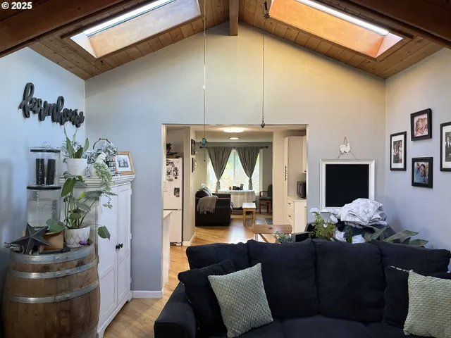 a living room with furniture and a mirror