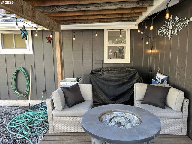 a view of a porch with furniture and a backyard