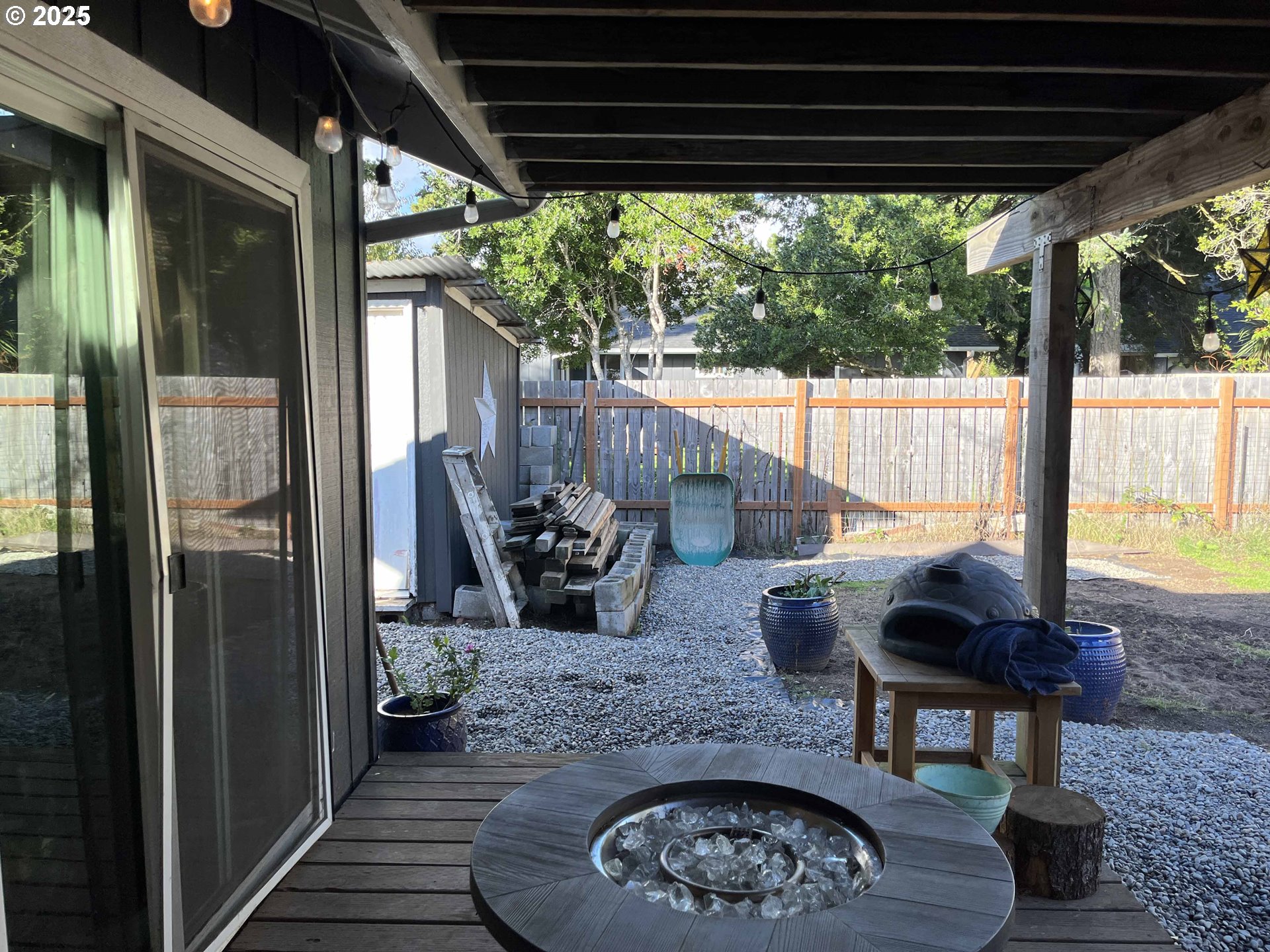 2045 19th Street Florence, OR 97439 - Photo 37 of 43 a view of a porch with furniture and a backyard