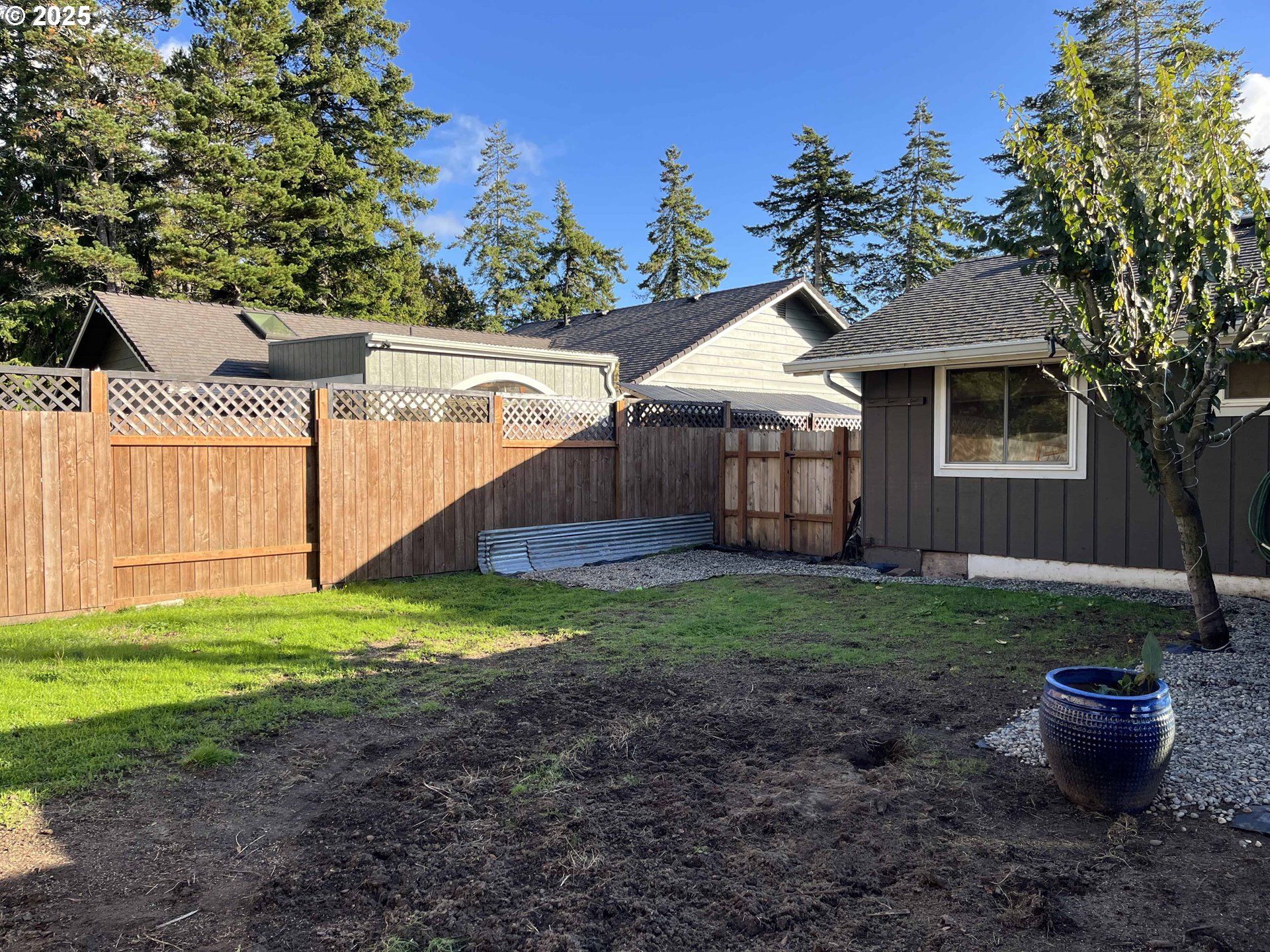 2045 19th Street Florence, OR 97439 - Photo 40 of 43 a backyard of a house with lots of green space
