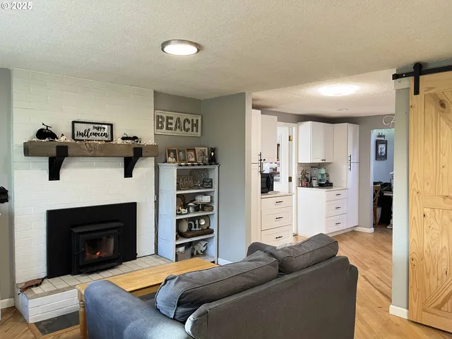 a living room with lots of books and a fireplace