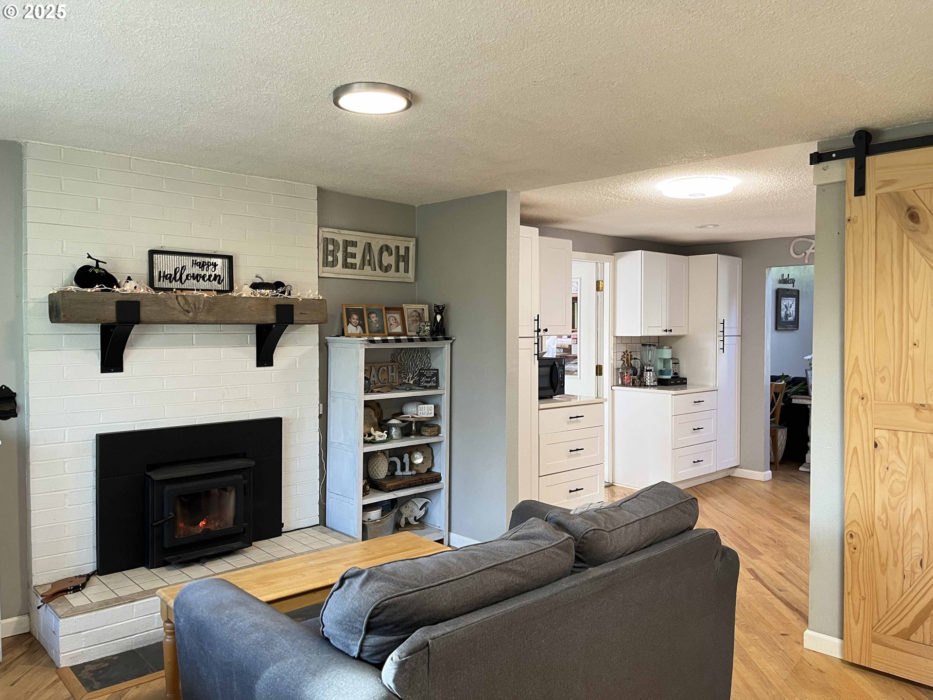 2045 19th Street Florence, OR 97439 - Photo 8 of 43 a living room with furniture and a fireplace